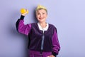 Senior happy woman with yellow dyed hair working out with dumbbells Royalty Free Stock Photo
