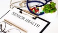 SENIOR HEALTH text and Background of Medicaments, Stethoscope Royalty Free Stock Photo