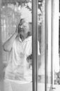 Senior healthy concept,Mature Asian elderly woman having migraine and headache pain near window at home,Black and white toned Royalty Free Stock Photo