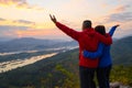 Senior healthy couple hiked the hill to see the sunrise view over Mekong river in morning Royalty Free Stock Photo