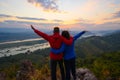 Senior healthy couple hiked the hill to see the sunrise view over Mekong river at Phu Pha Dak hill in Nong Khai Royalty Free Stock Photo