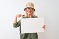 Senior hiker woman wearing canteen hat holding banner over isolated white background with surprise face pointing finger to himself Royalty Free Stock Photo