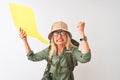 Senior hiker woman wearing canteen holding speech bubble over isolated white background annoyed and frustrated shouting with Royalty Free Stock Photo