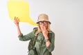 Senior hiker woman wearing canteen holding speech bubble over isolated white background cover mouth with hand shocked with shame Royalty Free Stock Photo