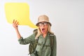 Senior hiker woman wearing canteen holding speech bubble over isolated white background scared in shock with a surprise face, Royalty Free Stock Photo