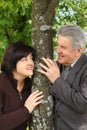 Senior and his daughter standing near tree Royalty Free Stock Photo