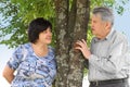 Senior and his daughter standing near tree Royalty Free Stock Photo