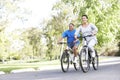 Senior Hispanic Couple Cycling In Park
