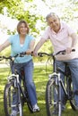 Senior Hispanic Couple Cycling In Park Royalty Free Stock Photo