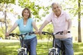 Senior Hispanic Couple Cycling In Park Royalty Free Stock Photo