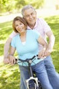 Senior Hispanic Couple Cycling In Park Royalty Free Stock Photo