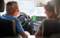 Senior Hispanic Couple On Drive Through Countryside Using Sat Nav On Mobile Phone Royalty Free Stock Photo