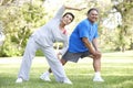 Senior Hispanic Couple Exercising In Park Royalty Free Stock Photo