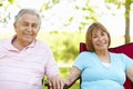 Senior Hispanic Couple Relaxing In Park