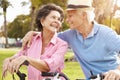 Senior Hispanic Couple Riding Bikes In Park Royalty Free Stock Photo