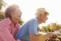 Senior Hispanic Couple Riding Bikes In Park Royalty Free Stock Photo