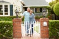 Senior Hispanic couple standing outside home Royalty Free Stock Photo