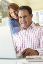 Senior Hispanic Couple Using Laptop In Home Office Royalty Free Stock Photo