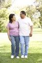 Senior Hispanic Couple Walking In Park Royalty Free Stock Photo