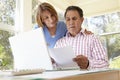 Senior Hispanic Couple Working In Home Office Royalty Free Stock Photo