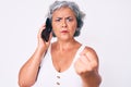 Senior hispanic grey- haired woman having conversation talking on the smartphone annoyed and frustrated shouting with anger, Royalty Free Stock Photo