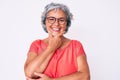 Senior hispanic grey- haired woman wearing casual clothes and glasses looking confident at the camera smiling with crossed arms Royalty Free Stock Photo