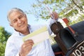 Senior Hispanic Man Checking Mailbox