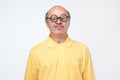 Senior hispanic man looking at camera wearing funny glasses Royalty Free Stock Photo