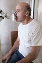 Senior hispanic man man testing breathing function by spirometry