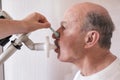 Senior hispanic man man testing breathing function by spirometry