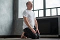 Senior hispanic man practicing yoga at home in vajrasana pose Royalty Free Stock Photo