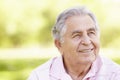 Senior Hispanic Man Relaxing In Park Royalty Free Stock Photo