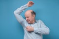 Senior hispanic man with sweat stain on his shirt suffering from hot weather. Royalty Free Stock Photo