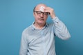 Senior hispanic man with sweat stain on his shirt suffering from hot weather. Royalty Free Stock Photo