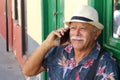 Senior Hispanic man using cellphone outdoors Royalty Free Stock Photo