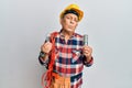 Senior hispanic man wearing handyman uniform holding led lightbulb and incandescent bulb looking at the camera blowing a kiss Royalty Free Stock Photo