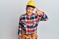 Senior hispanic man wearing handyman uniform smiling doing phone gesture with hand and fingers like talking on the telephone Royalty Free Stock Photo