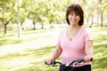 Senior Hispanic woman with bike