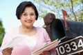 Senior Hispanic Woman Checking Mailbox Royalty Free Stock Photo