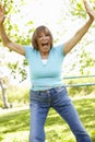 Senior Hispanic Woman With Hula Hoop In Park Royalty Free Stock Photo