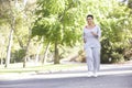 Senior Hispanic Woman Jogging In Park