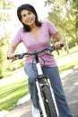 Senior Hispanic Woman Riding Bike In Park Royalty Free Stock Photo
