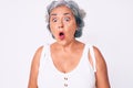 Senior hispanic woman wearing casual clothes scared and amazed with open mouth for surprise, disbelief face Royalty Free Stock Photo