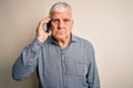 Senior hoary man having conversation talking on the smartphone over white background with a confident expression on smart face