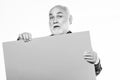 Senior holding blank sign board and looking at camera. Elderly people. Man bold head and gray beard hold poster for Royalty Free Stock Photo