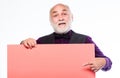 Senior holding blank sign board and looking at camera. Man bold head and gray beard hold poster for advertisement copy Royalty Free Stock Photo