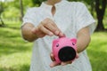 Senior holding piggybank in hand