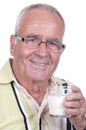 Senior holdsa glass of milk in hand Royalty Free Stock Photo