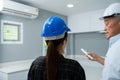 Senior home inspector checking home defects and teaching young engineers, before handing it over to client. Young engineers learn