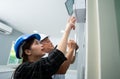 Senior home inspector checking home defects and teaching young engineers, before handing it over to client. Young engineers learn